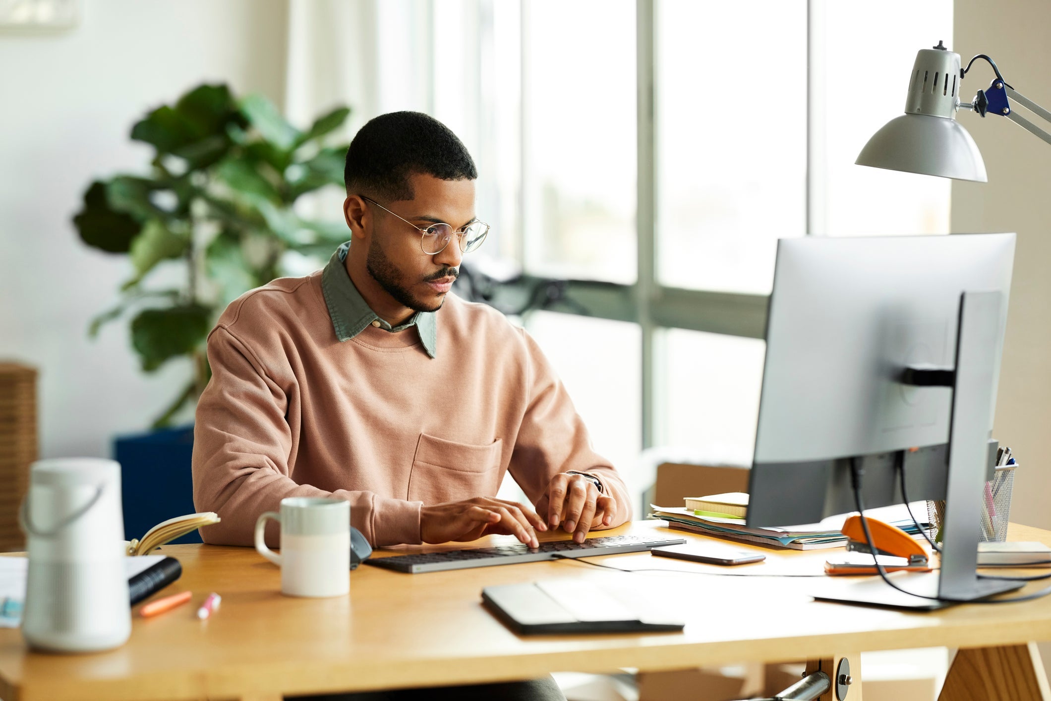 Male Freelancer Using Computer At Home Office
