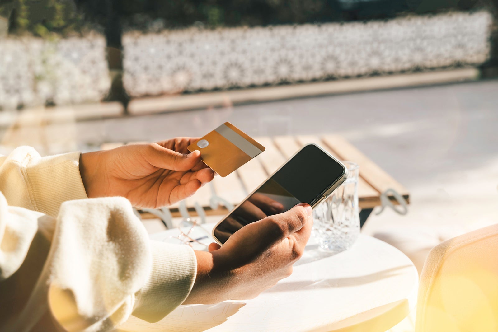 Woman using a credit card to pay online bills using mobile application