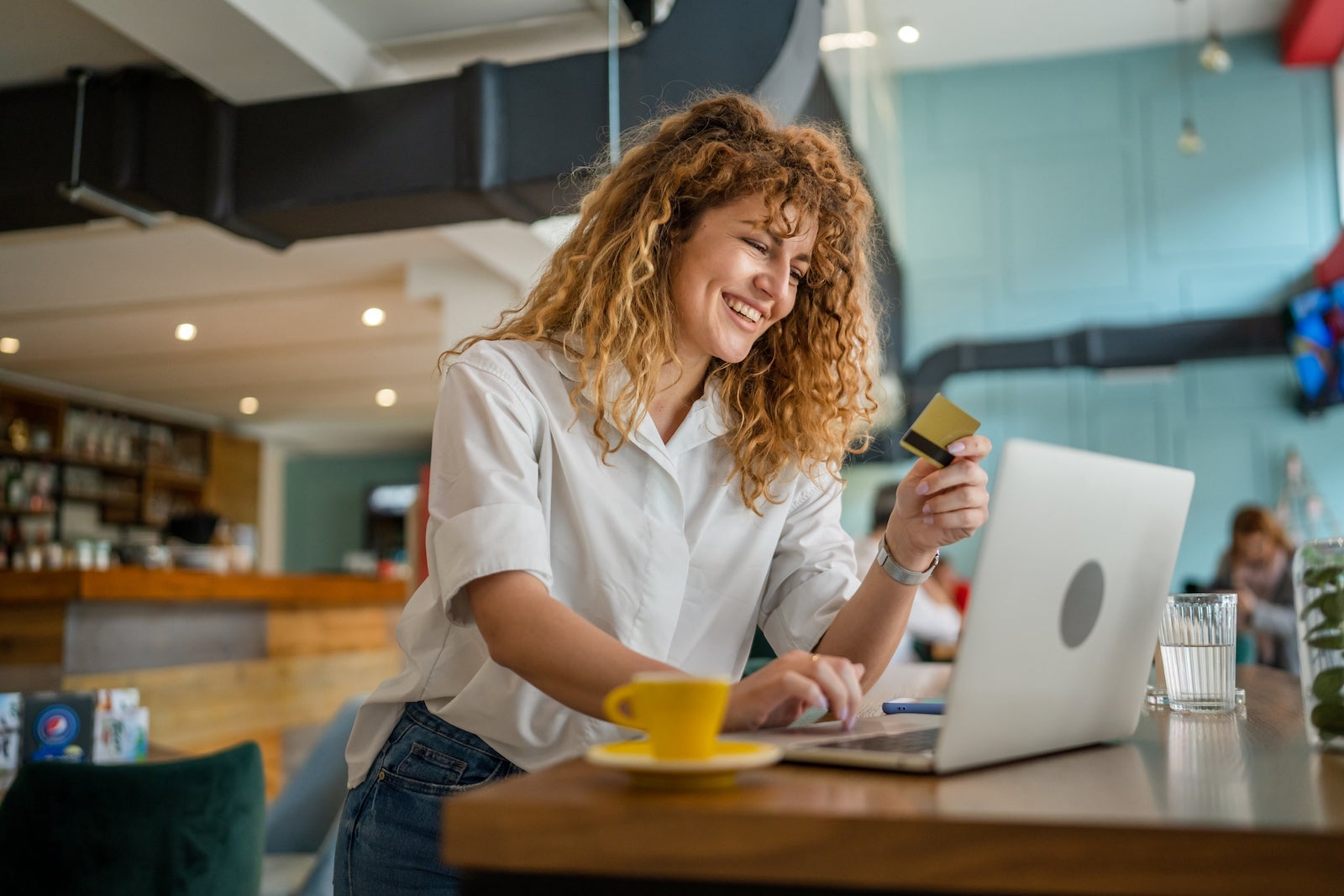 Woman happy caucasian female shopping online use credit card at cafe