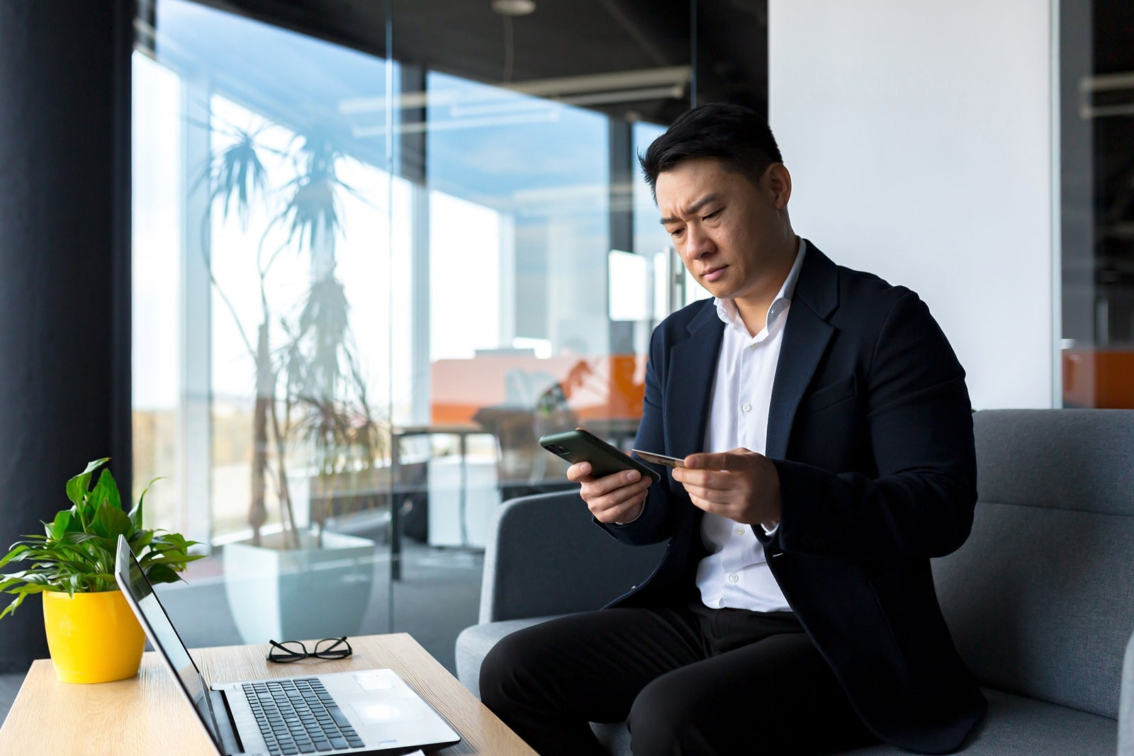 Unhappy Confused, angry asian man shopping online. customer cannot pay by bank credit card. having problems paying feel frustrated stressed with failed transaction internet on computer laptop screen