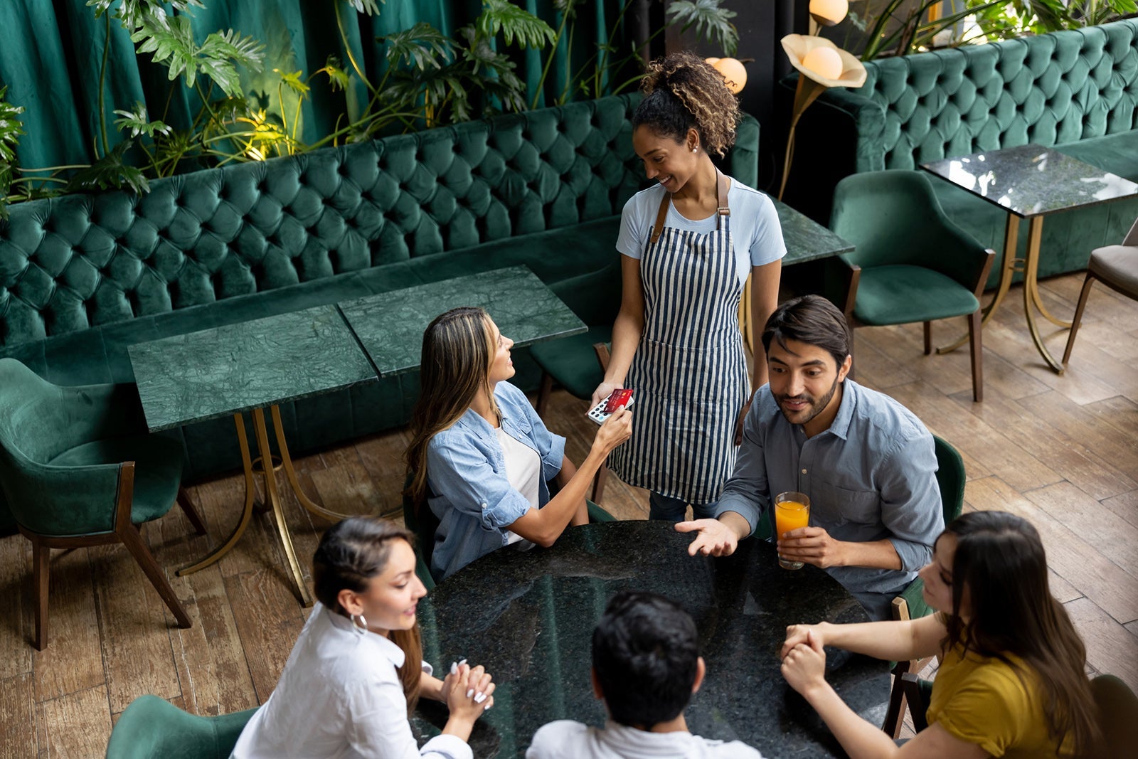 Woman paying by card at a restaurant