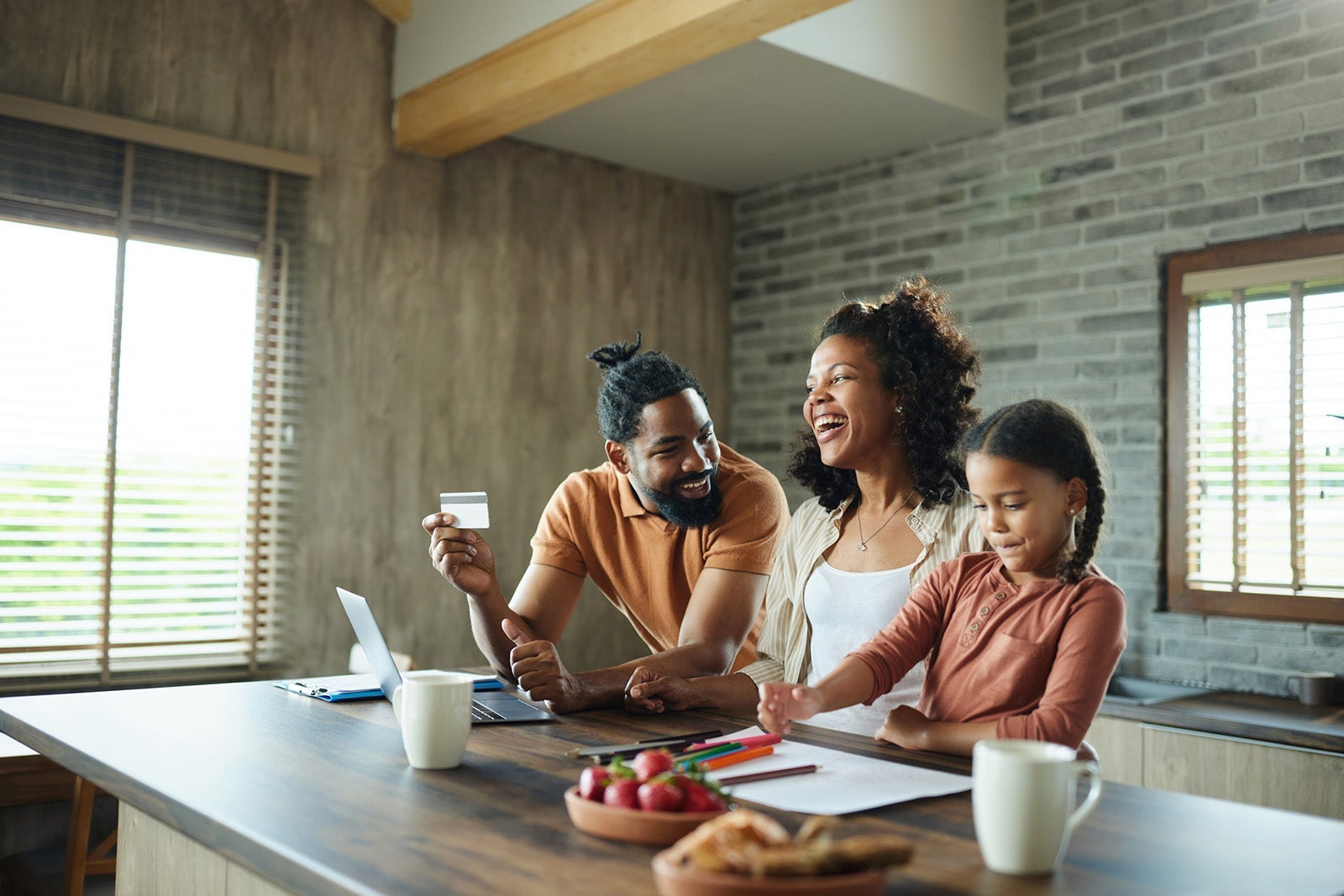 Happy black family shopping online at home.