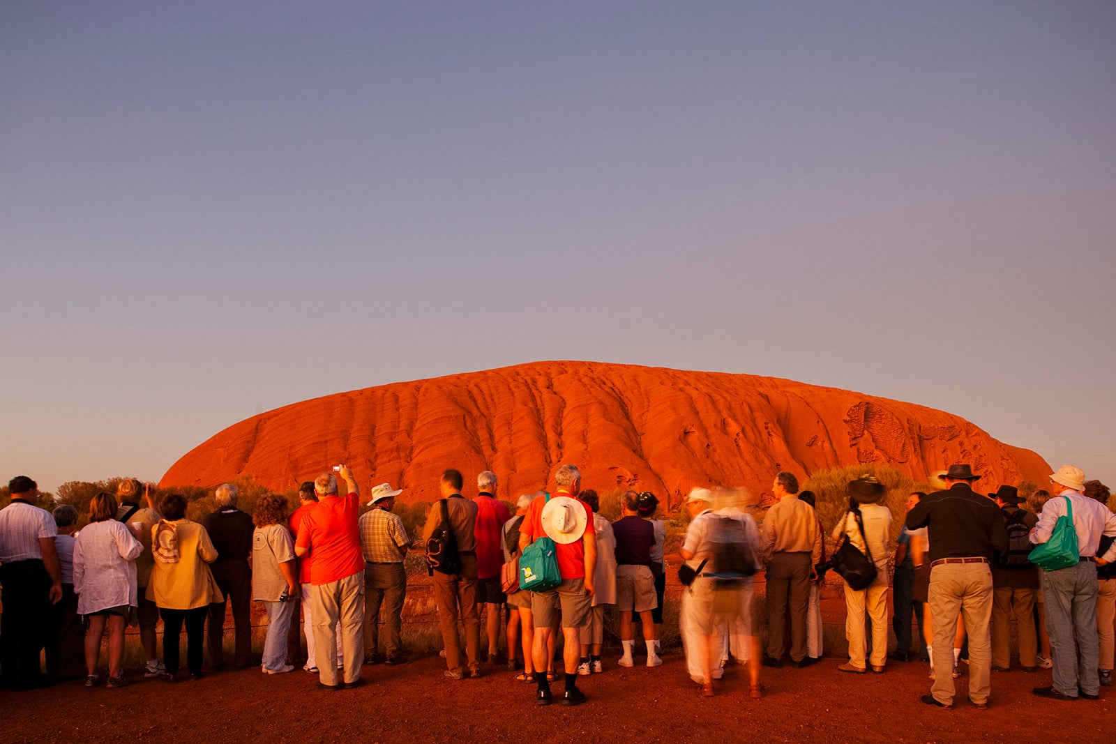 Tourists View Ayers Rock Just Past Sunset, in the Australian Outback