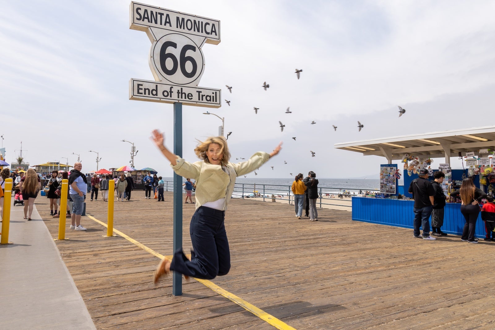 Samantha celebrates the end of her Route 66 trip on the Santa Monica Pier by Samantha Isom