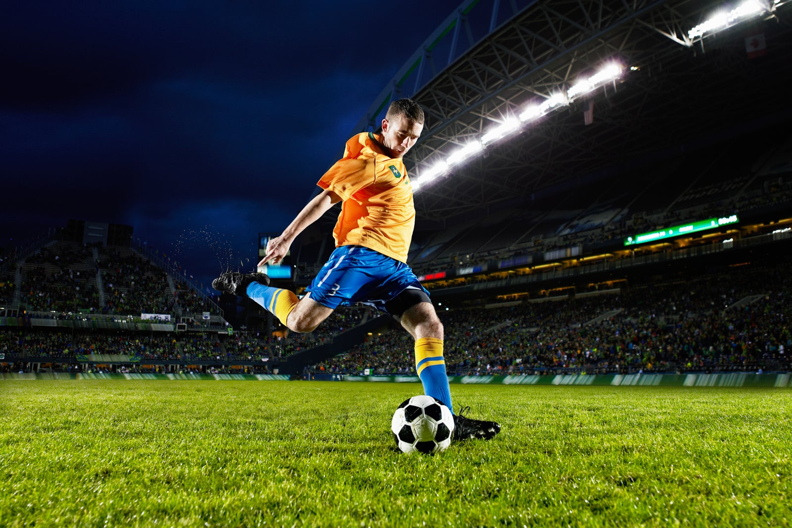 Soccer player about to kick ball on field